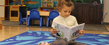 young girl reading a book 