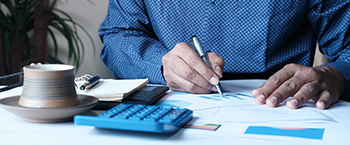 Image showing someone writing at a desk