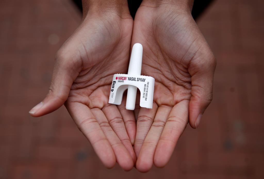 person holding narcan spray