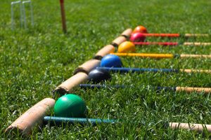 Croquet mallets and balls in the grass